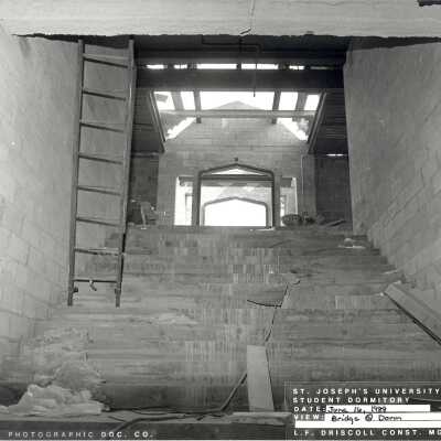 View of entrance to pedestrian bridge of McShain Hall under construction.