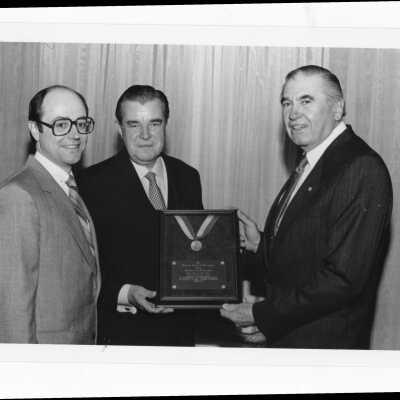 Francis P. Burns, III, and Edward J. Quinn, with William A. Conway, recipient of Bartholomew A. Sheehan, S.J. Award (formerly Crim-Gray Award) at Law Alumni dinner, 1988.