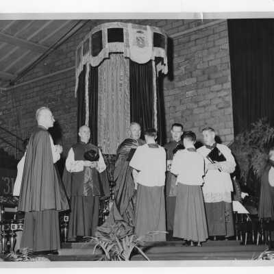 Pontifical mass in Field House as part of centennial celebration, October 28, 1951, with Monsignor Crean, Monsignor Vincent Burns, Monsignor Francis Furey, Monsignor oseph McShea, and Amleto Giovanni Cicognani