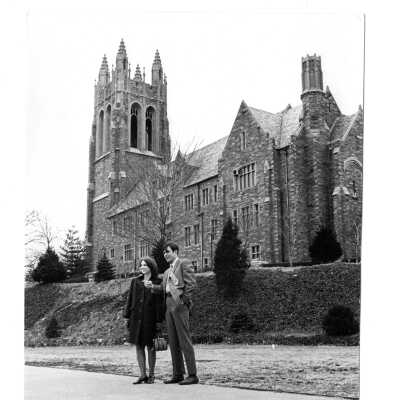 Couple in dress clothes with Barbelin building in background.