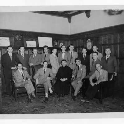 Thomas J. Stokes, S.J. with student staff members of Crimson and Gray.