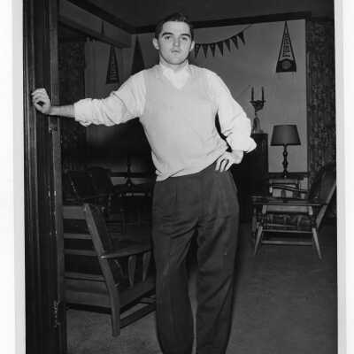 Student resident of Quirk Hall standing in living room.