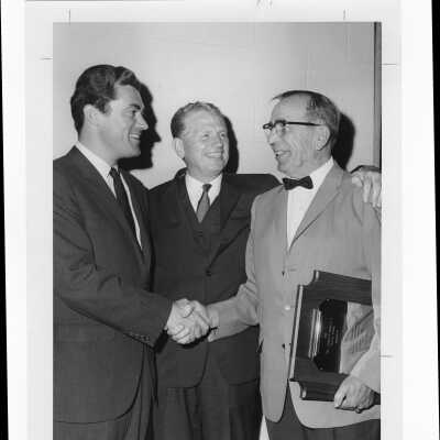 Edward J. Fleming receiving Hogan Alumni Award with Congressman William J. Green, III, and Lieutenant Governor Broderick watching, May 16, 1969.