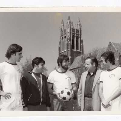 Men soccer team members with Coach Ed Blane, 1975.