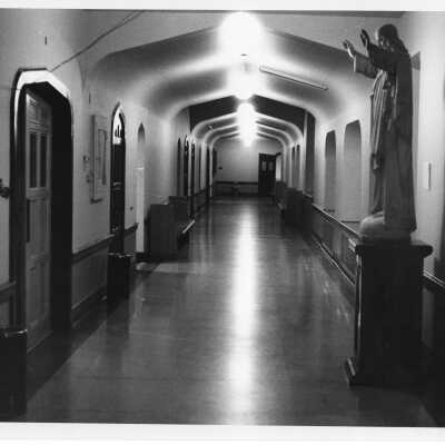 Interior view of hallway in Barbelin with statue of Jesus.