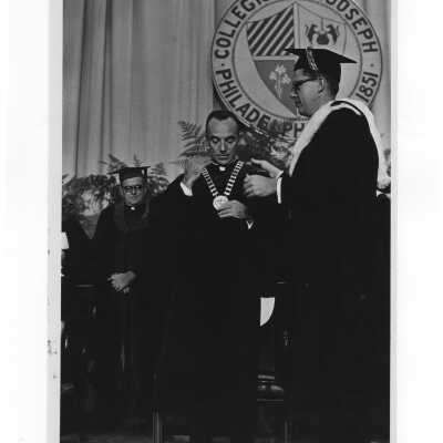 Inauguration of President Terrence Toland, S.J., November 14, 1968. Jerome Coll, S.J. invests Father Toland with the Chain of Office.