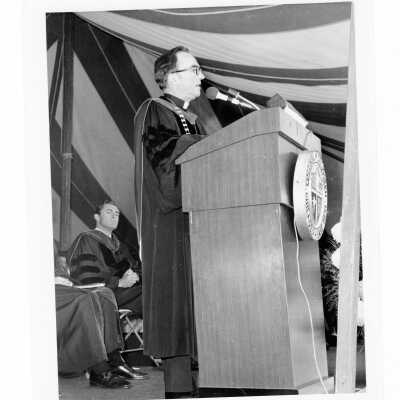 Terrence Toland, S.J., addressing graduates with William J. Green III listening during 1976 graduation/commencement.