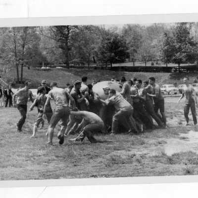 Student in pushball contest in mud during Junior Week activities.