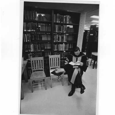 Inauguration of President Terrence Toland, S.J., November 14, 1968. Before ceremony, Faculty member waits in Drexel Library for academic procession.