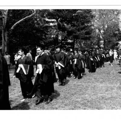 Graduating students processing to Gest Lawn during graduation/commencement, c. 1984.