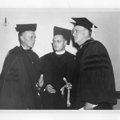 Edward G. Jacklin, S.J., with honorary degree recipients, Thomas K. Finletter and John Foster Dulles, during academic convocation, October 28, 1951, as part of centennial celebration.