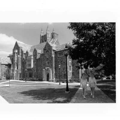 Exterior front view of Barbelin building with two students walking.
