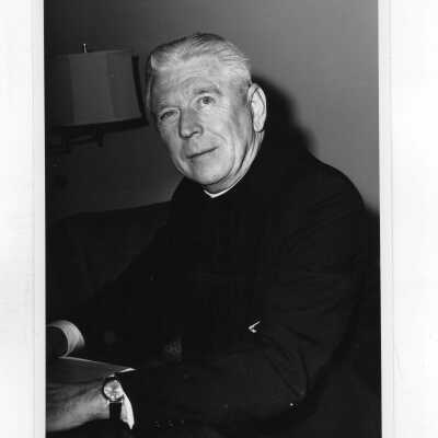Lawrence R. McHugh, S.J., sitting at desk.