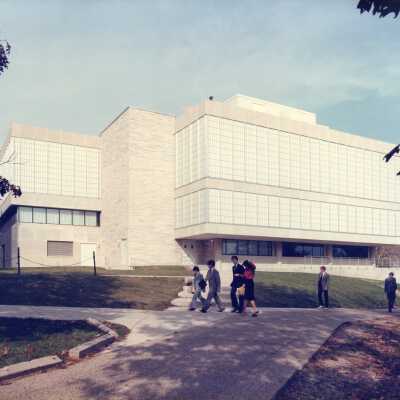 Exterior rear view of new wing or addition of Drexel Library with students walking by.
