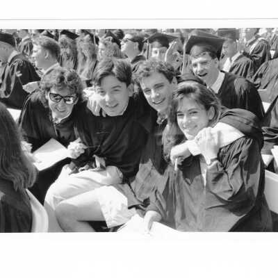 Views of small groups of graduating students during graduation/commencement, c. 1993.