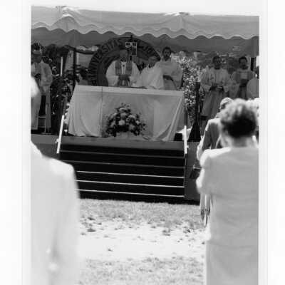 View of Baccalaureate mass on Gest Lawn with Donald I. MacLean, S.J., and others, graduation/commencement, c. 1985.