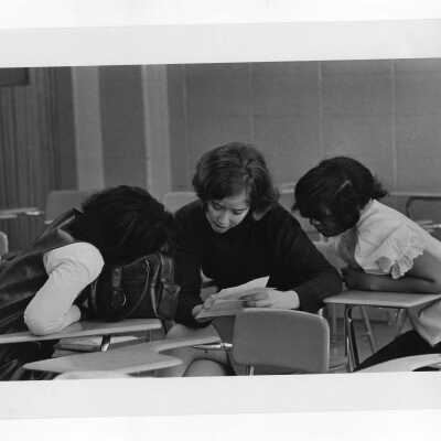 Woman student tutoring children at Rhoads Public School as part of community service/outreach project. (Part of Peace and Human Development Program?)