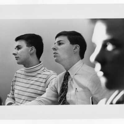 Three male students listening to lecture.