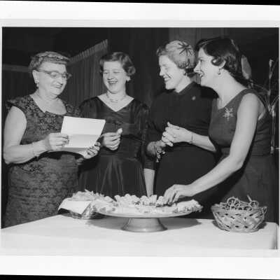 Several wives of alumni association members planning an event, January 5, 1958, Includes Mrs. Joseph Cox, Mrs. William Noone, Mrs. William Deasey, and Mrs. Carmen Casciato.