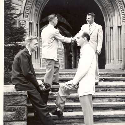Students arriving for fall term and standing in front of archway entrance to Barbelin building. Students include Richard Thoden, Gilbert Smith, Raymond Dion, and Charles Carr.