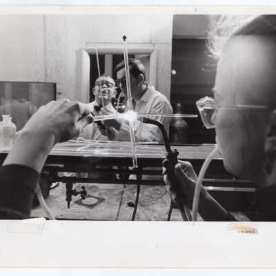 Students and professor in glass blowing course offered by Chemistry Department, c. 1965.