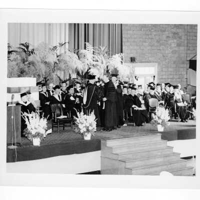 J. Joseph Bluett, S.J., conferring honorary degree to John F. Horstmann (?) during 1959 graduation/commencement ceremony.