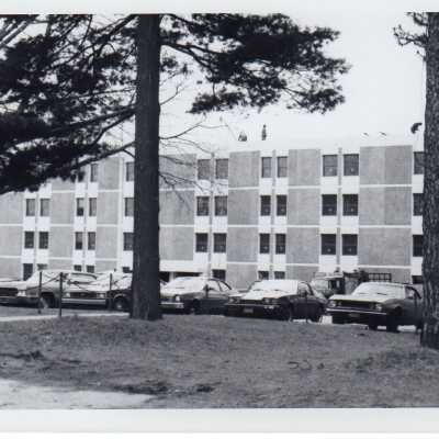 View of parking lot with cars in front of Sourin Residence Center.