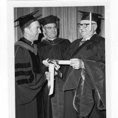 Terrence Toland, S.J., and Michael J. Smith, S.J., with honorary degree recipient, Harry Boyer (?)