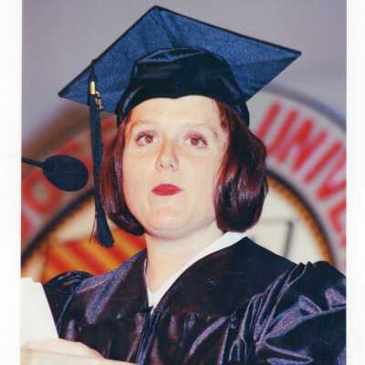 Graduate student, possibly Shana Maier, addressing audience during 1999 graduation/commencement.