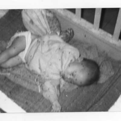 Vietnamese child sleeping in crib, Vietnam Orphanage project.