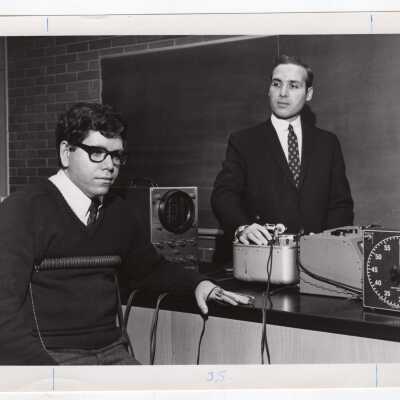 Psycholgy professor, I. Ralph Hyatt, with student demonstrating how the lie detector machine works, March 1968.