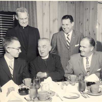 View of alumni association planning meeting with William Deasey (?), Michael Smith, S.J., Joseph S. Hogan, S.J, and Joseph Pascucci.