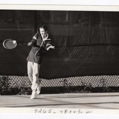 Women's tennis team team member practicing.