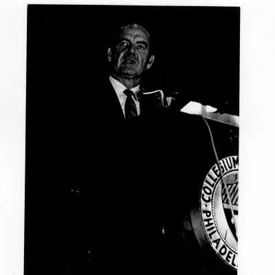 Senator George McGovern delivering speech from podium in Field House, October 2, 1969.