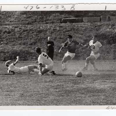 Men's soccer match with Emory Ross, S.J. watching.