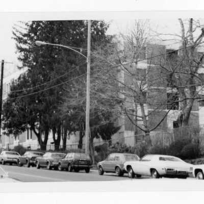 View of cars parked on Cardinal Avenue with Sourin Residence Center in background.