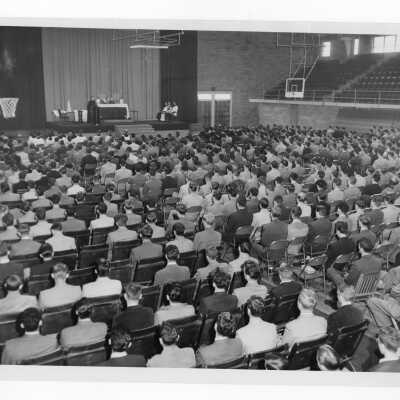 Edward G. Jacklin, S.J., addressing students after Mass of the Holy Spirit in Field House, September 1950.