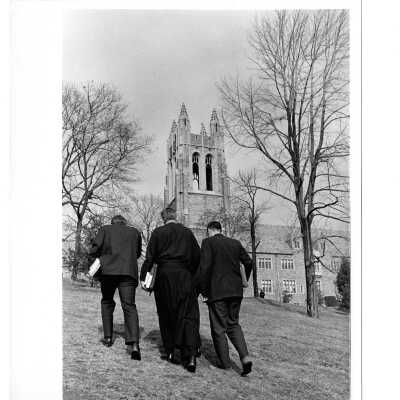 Jerome Coll, S.J. and two students walking up hill near Barbelin building.