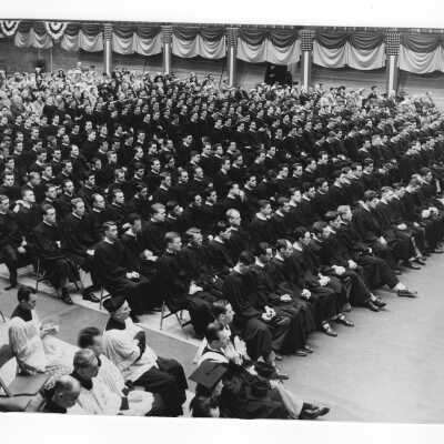 View of students, guests, and Jesuits at Baccalareate service in Field House as part of 1951 graduation/commencement.