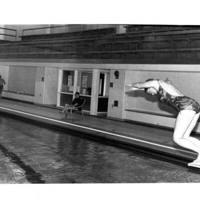Student diving into pool in Sports Complex.