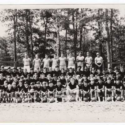 Group photo of boys summer basketball camp with sixty campers and ten coaches.