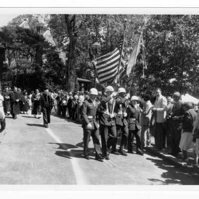 Color guard and faculty processing toward Gest Lawn during graduation/commencement, c. 1985.