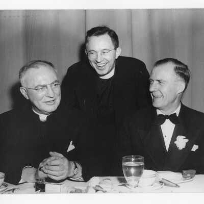Matthew G. Sullivan, S.J., with two guests during banquet held in Field House as part of centennial anniversary celebration.