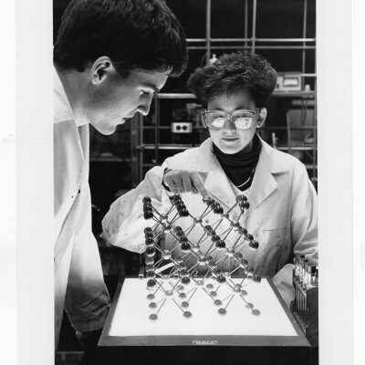 Two students working in science laboratory.