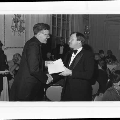 Donald I. MacLean, S.J., handing awards to Carl J. Gregorio, Peter McGoldrick, Joseph J. Murphy, and Charles F. Murphy at alumni awards dinner, c. 1980.