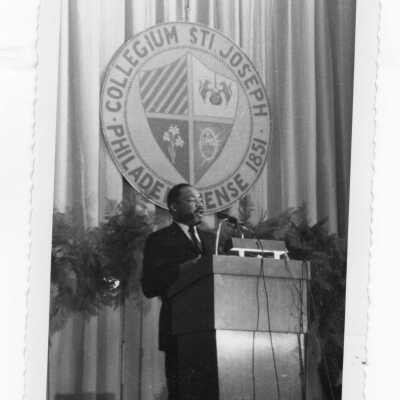 Dr. Martin Luther King, Jr. delivering speech at Saint Joseph's College, October 26, 1967 in Field House.