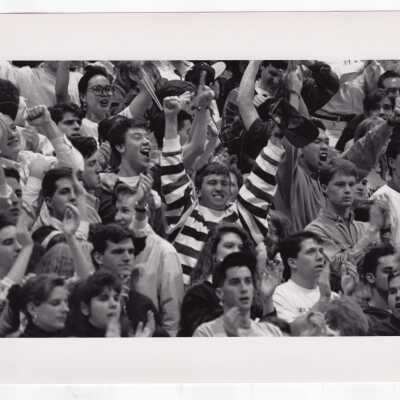 Students cheering at basketball game.
