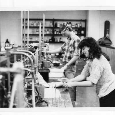Two students conducting experiment in science laboratory.