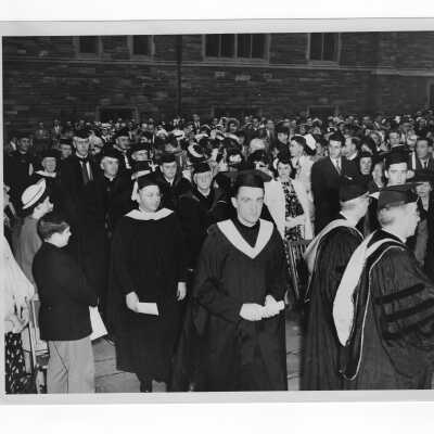 Students and faculty processing into Barbelin quadrangle during 1947 graduation/commencement ceremony.