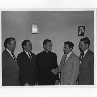 Edward G. Jacklin, S.J., with alumni officers, Francis Lammer, William Ariano, and William R. Deasey (?), c. 1953.